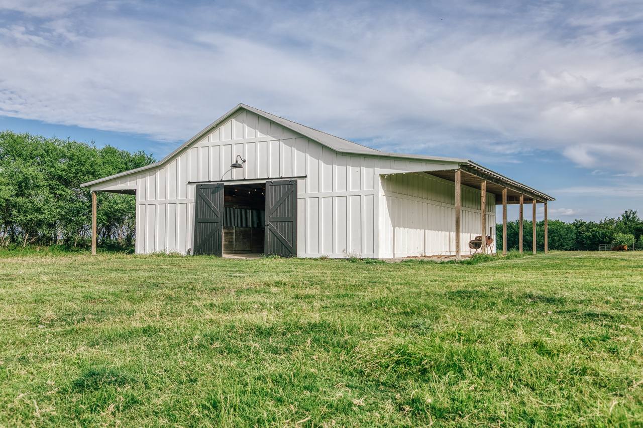 White 6-stall barn with sliding doors