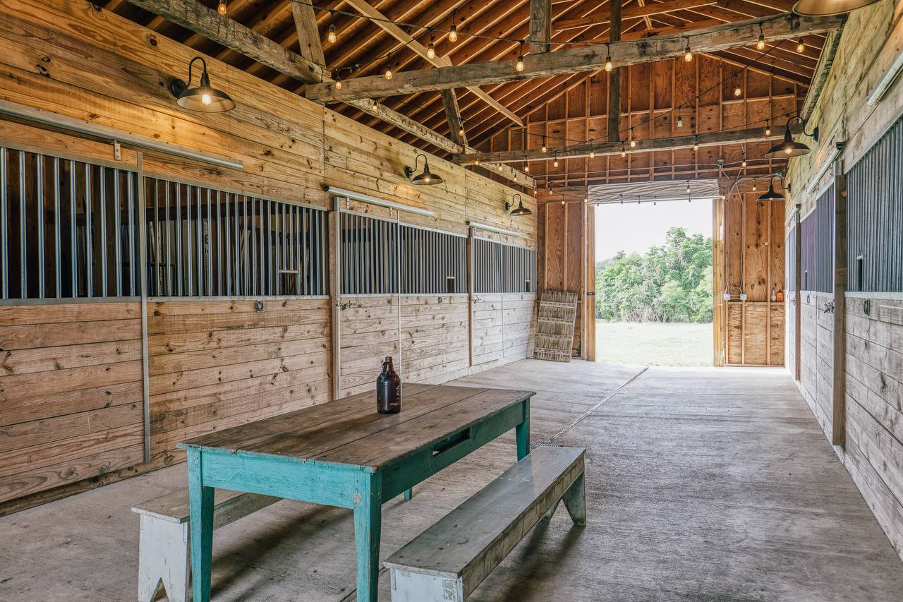 Barn interior with stalls and string lights