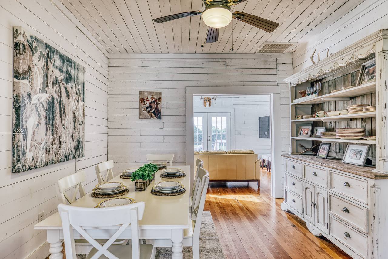 Dining room looking into kitchen — shiplap walls, butcher block counters