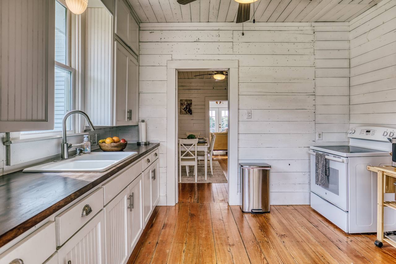Kitchen — beadboard cabinets, butcher block, shiplap