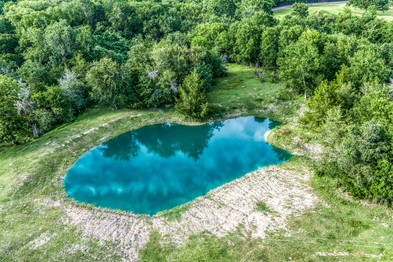 Aerial view of the stocked pond — stunning turquoise water